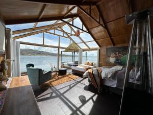 a living room with a view of the water at Hotel - Titicaca Dora in Puno