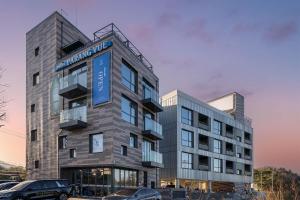 a building with a blue sign on the side of it at Hotel Parangvue in Goseong