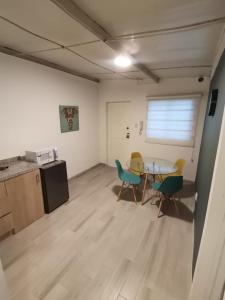 Habitación con mesa, sillas y cocina. en Suite Doble en Parque la Carolina, en Quito