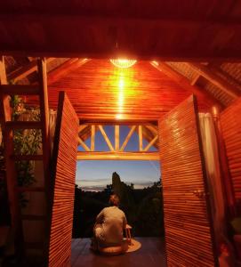 a man sitting on a chair in a wooden house at SMALL CABIN IN THE SOUTH 