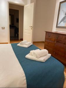 two towels are sitting on top of a bed at Vicario138 in Rome