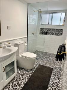 a bathroom with a toilet and a sink and a shower at House of Mahalo BnB in Mapleton