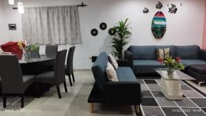 a living room with a blue couch and a table at Casa Gacela Cozumel in Cozumel