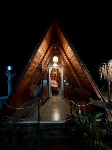 a small house with a wooden roof at night at Hotel Luna Azul Tatacoa in Villavieja