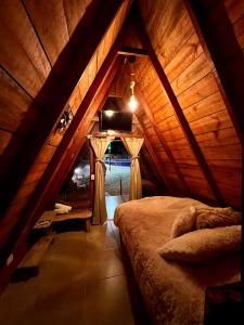 a bedroom with a bed in a wooden attic at Hotel Luna Azul Tatacoa in Villavieja
