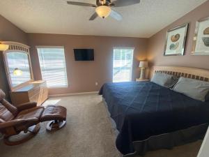 a bedroom with a blue bed and a ceiling fan at 3 Bedroom Villa with Poolside Cinema and Games Room Close to theme Parks sleeps 6 plus 2 in Orlando