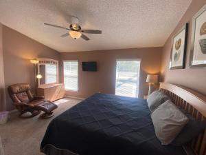a bedroom with a bed and a ceiling fan at 3 Bedroom Villa with Poolside Cinema and Games Room Close to theme Parks sleeps 6 plus 2 in Orlando