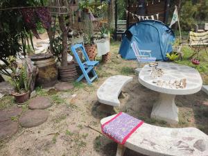 a table and chairs and a tent in a yard at Peace home kpg in Baan Khai