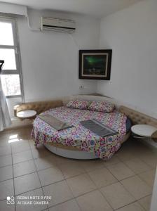 a bedroom with a bed and a tv on the wall at Eilat in Eilat