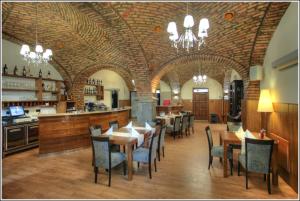 a dining room with tables and chairs in a restaurant at Bokun Apartments I in Sisak