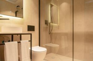 a bathroom with a toilet and a glass shower at The Valentia Corretgería in Valencia