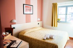 Ένα ή περισσότερα κρεβάτια σε δωμάτιο στο Lizard Hotel