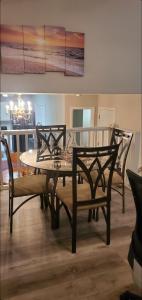 a dining room with a table and two chairs at Central Pointe Pad in Riverdale