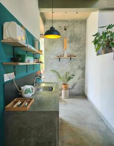 a kitchen with a sink and a counter top at The Traveller Kandy in Kandy