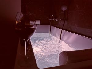 a glass of wine sitting next to a table with snow at Appart Hotel Spa Perpignan in Perpignan