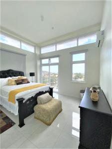 a bedroom with a large bed and a chair at Luxury 2 bed Apartment in Kingston in Kingston