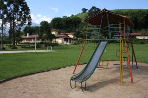 a playground with a slide in a park at Pousada Ribeirão do Ouro in Itamonte
