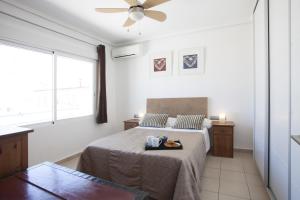 a bedroom with a bed and a ceiling fan at Carmen Apartments in Valencia