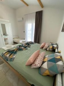 a bedroom with a large bed with pillows on it at Timm apartment in Vir