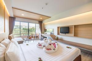 a hotel room with two swans on a bed at MATCHA SAMUI RESORT formerly Chaba Samui Resort in Chaweng