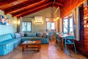 a living room with a blue couch and a table at Sea of Galilee Panoramic View in Moshav Ramot