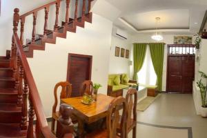 a dining room with a table and a staircase at Private and Unique Stay At Angkor Siem Reap in Phumĭ Réach Born (2)