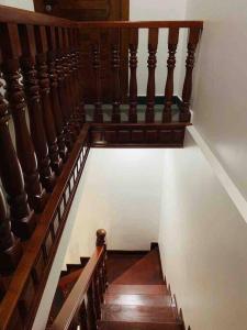 a staircase with wooden railings in a house at Private and Unique Stay At Angkor Siem Reap in Phumĭ Réach Born (2)