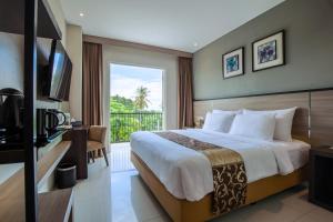 a hotel room with a bed and a balcony at Montana Premier Senggigi in Senggigi 
