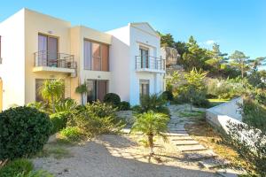 a house on the side of a hill with plants at Renata's Villas in Karpathos Town