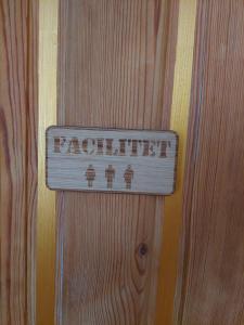 a sign on the side of a wooden door at Guest room in Uppsala
