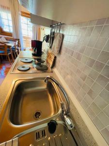 a kitchen with a sink and a stove at Haus Stabentheiner in Birnbaum