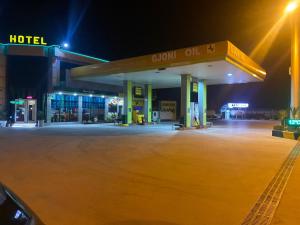 a gas station at night with a sign on it at Kompleksi GJONI in Fier