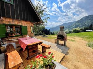 a patio with a table and an outdoor oven at Chalet Hike&Bike above Bohinj valley in Bohinj