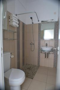 a bathroom with a toilet and a sink at Myrto Hotel in Kamares