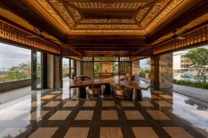 an open lobby with a table and large windows at AYANA Segara Bali in Jimbaran