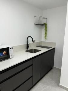 a kitchen with a sink and a microwave at מישל נופש ,יותם 6003 in Eilat