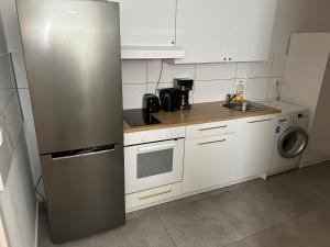a small kitchen with a refrigerator and a sink at Apartment for rent 2 in Celle