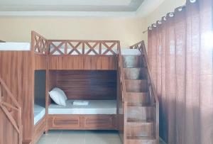 a bunk bed with a staircase in a room at RedDoorz @ Sundance Mountain Resort Tampilisan in Zamboanga