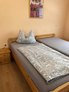a bed with two pillows on top of it at Haus Am Wald in Wasungen