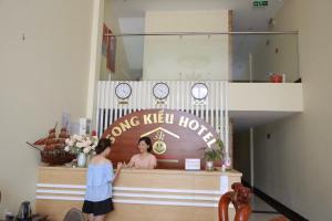 a woman standing in front of a long kyllords store at Song Kieu Hotel - Self check-in in Ha Long