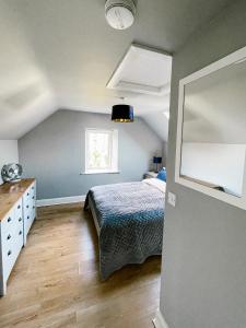 a bedroom with a bed and a window at Maytown Cottage in Rosslare