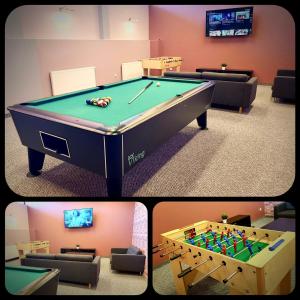 a room with a pool table and a tv at Hotel Szyndzielnia Eco in Bielsko-Biała