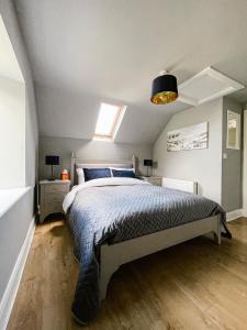 a bedroom with a bed and a skylight at Maytown Cottage in Rosslare