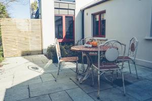 a table and chairs sitting on a patio at Maytown Cottage in Rosslare