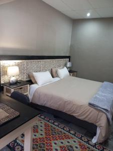a bedroom with a large bed in a room at Tucked-Away 1,2,3,bedroom houses in Nelspruit