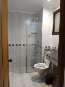 a bathroom with a shower and a toilet at Riviera palms 1 Luxury 1 BHK apartment with Swimmimg Pool view- Arpora - near baga beach in Old Goa
