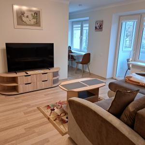 a living room with a large flat screen tv at Sweet home in Šiauliai