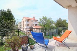 two chairs sitting on the balcony of a house at Merlini in Medulin +13 photos