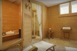 a wooden room with a tub and a window at Chalet Timan - OVO Network in La Clusaz
