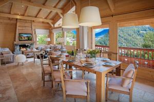 une salle à manger avec une grande table et des chaises en bois dans l'établissement Chalet Timan - OVO Network, à La Clusaz